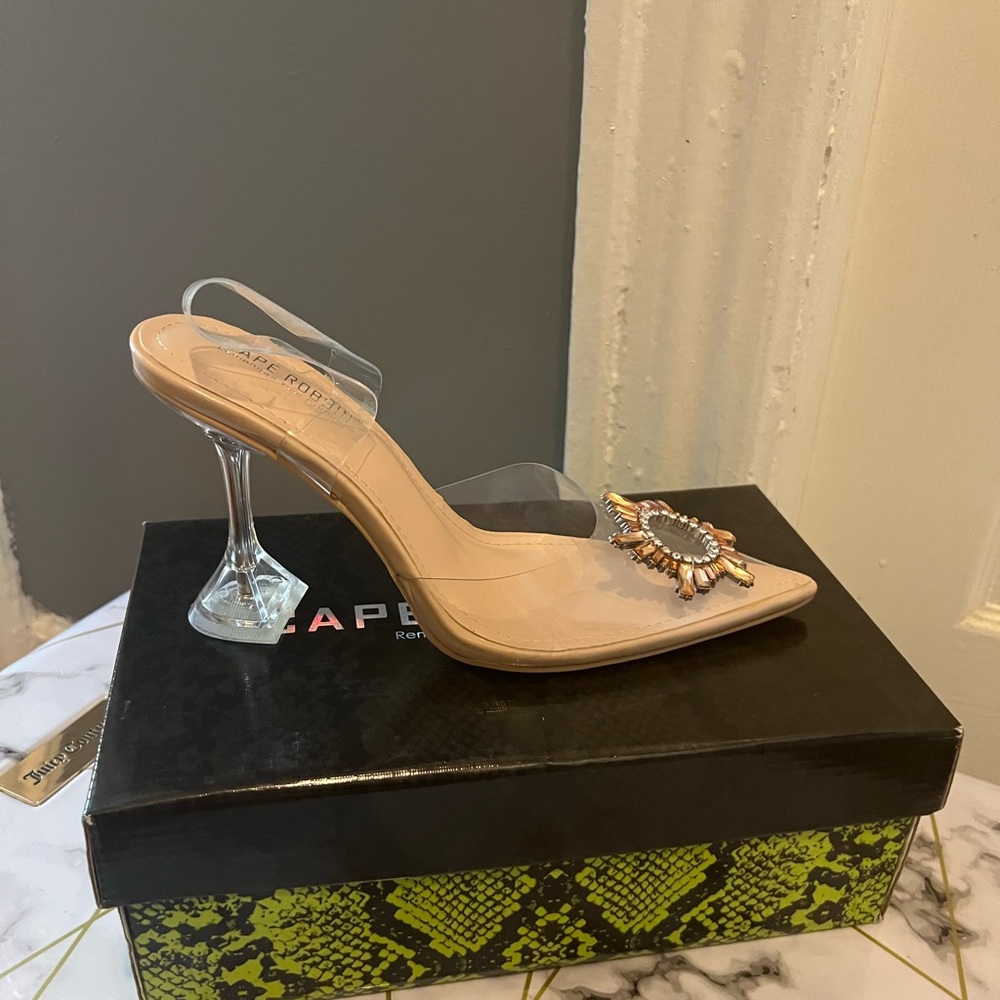 Transparent closed toe, strapped heel.